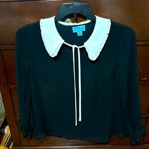 Woman’s sheer black blouse.